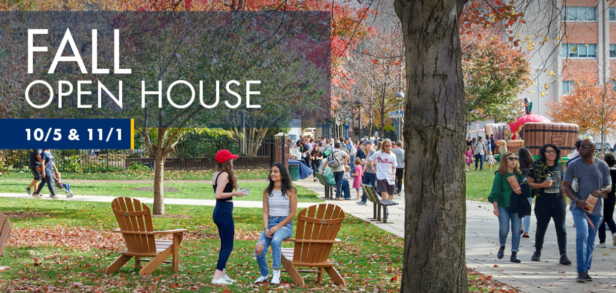 Students sitting on campus quad during autumn